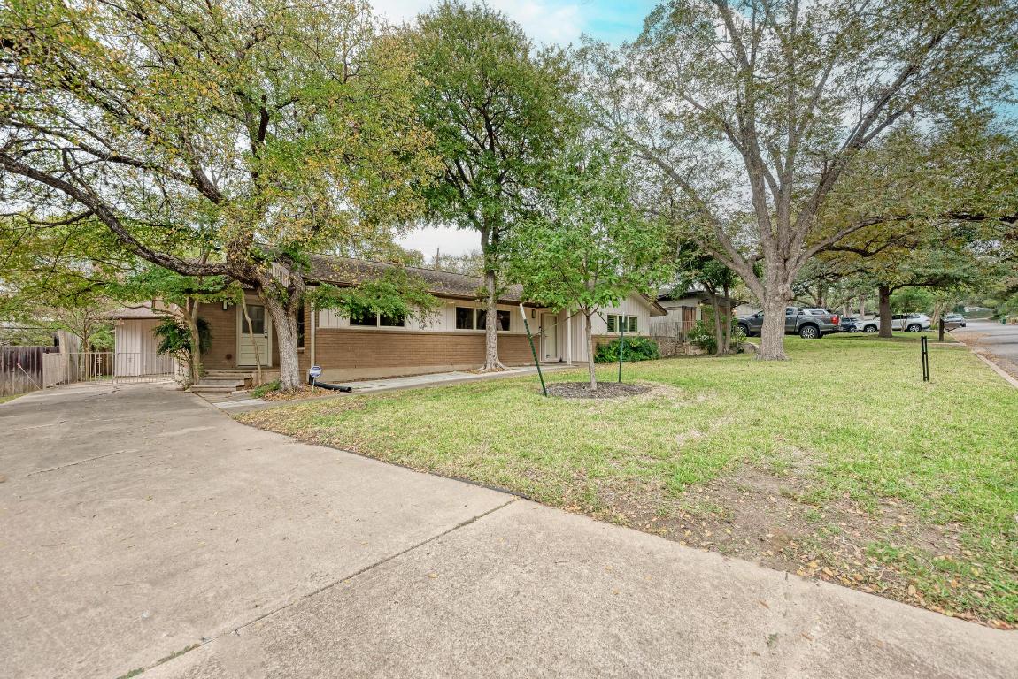 2500 Spring Creek Drive Austin, TX 78704 - Photo 6 of 40 front view of a house with a yard and an trees