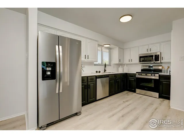 a kitchen with stainless steel appliances a refrigerator stove microwave and sink