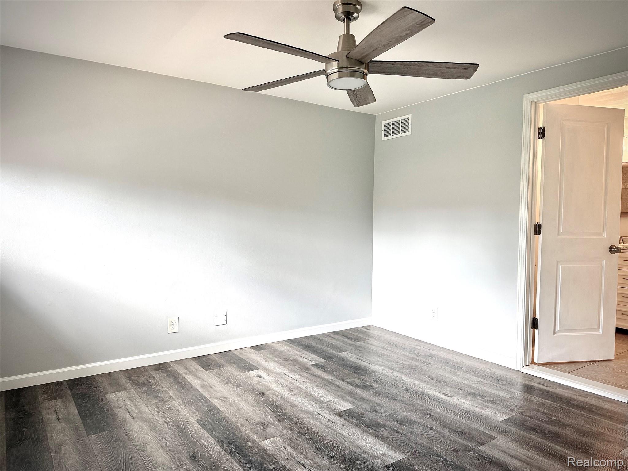 2852 Trailwood Drive Rochester, MI 48309 - Photo 21 of 28 Wood-finish flooring with white trim, a modern ceiling fan, and light-toned walls