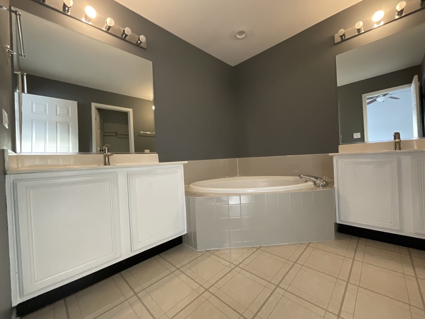 1116 Village Center Parkway, Unit 4 Aurora, IL 60506 - Photo 11 of 20 a bathroom with a white tub shower vanity and sink