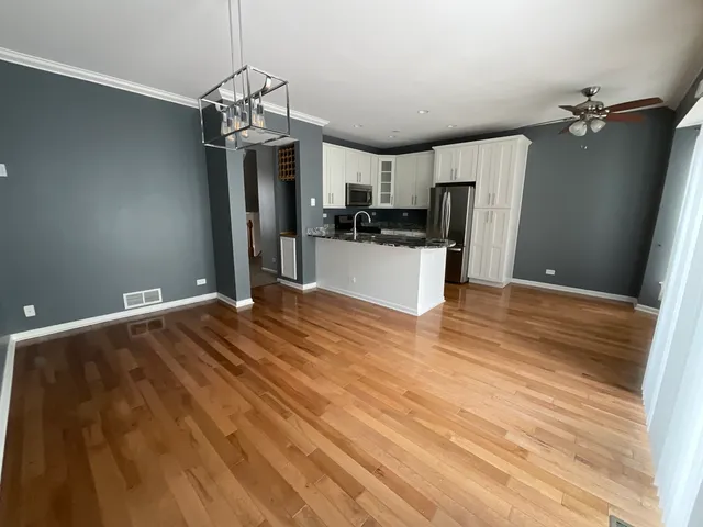 a very nice looking room with a large bed a flat screen tv and a chandelier