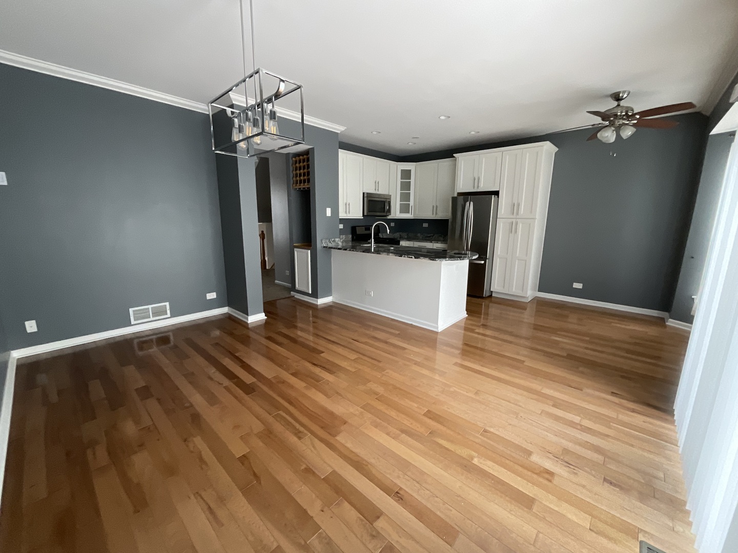 1116 Village Center Parkway, Unit 4 Aurora, IL 60506 - Photo 5 of 20 a very nice looking room with a large bed a flat screen tv and a chandelier