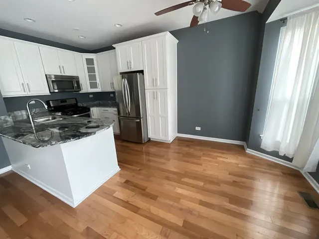 a kitchen with stainless steel appliances a refrigerator stove microwave and sink