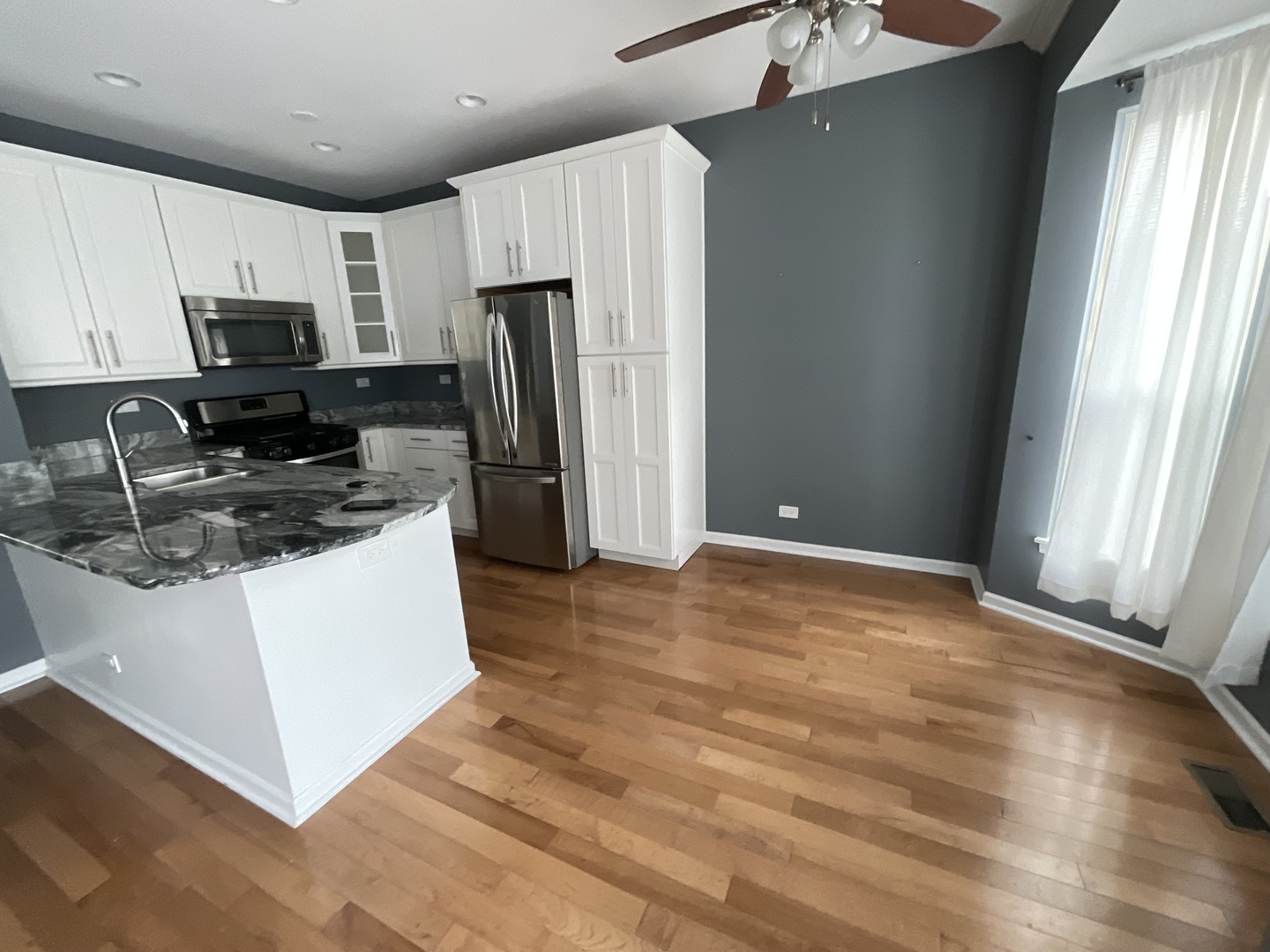 1116 Village Center Parkway, Unit 4 Aurora, IL 60506 - Photo 6 of 20 a kitchen with stainless steel appliances a refrigerator stove microwave and sink