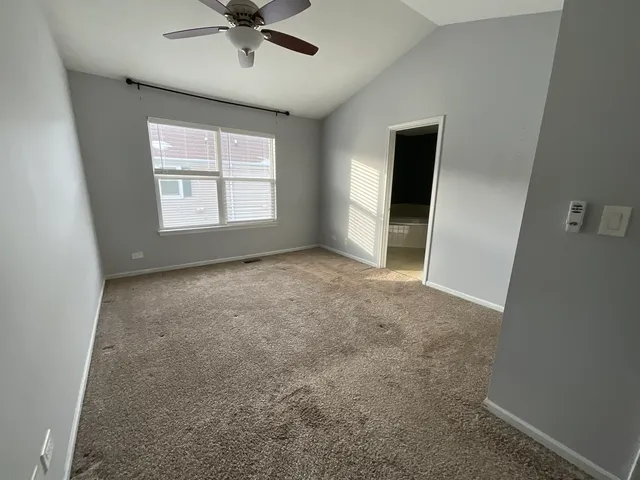 a view of a livingroom with a ceiling fan and window