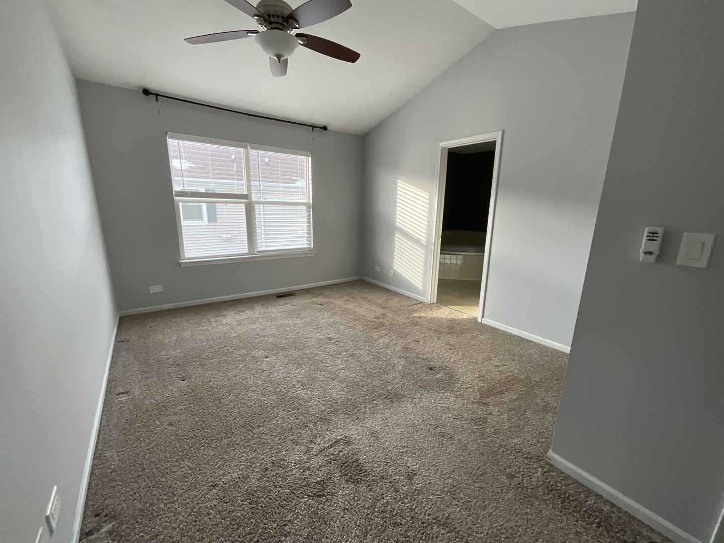 1116 Village Center Parkway, Unit 4 Aurora, IL 60506 - Photo 10 of 20 a view of a livingroom with a ceiling fan and window