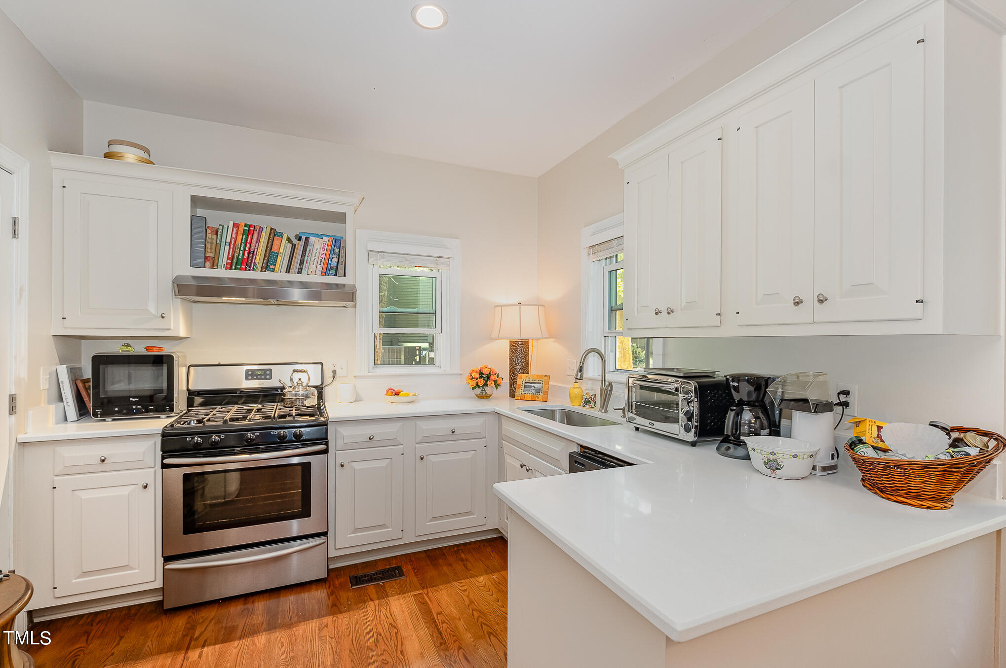 1715 Falls Church Road Raleigh, NC 27609 - Photo 12 of 19 a kitchen with white cabinets and appliances