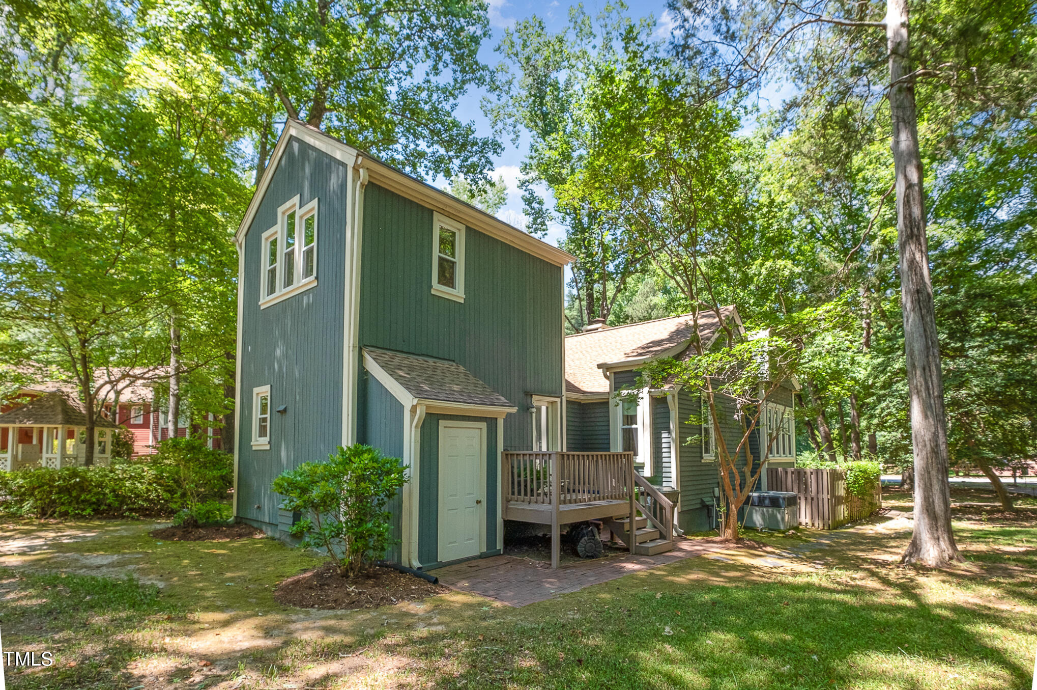 1715 Falls Church Road Raleigh, NC 27609 - Photo 17 of 19 a backyard of a house with table and chairs large trees