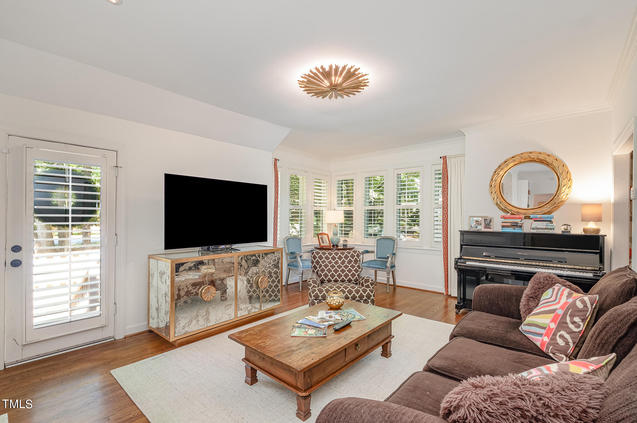 1715 Falls Church Road Raleigh, NC 27609 - Photo 7 of 19 a living room with furniture a flat screen tv and a large window