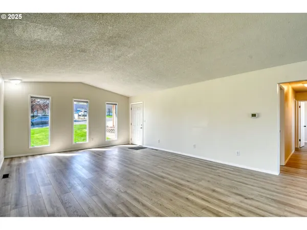 a open kitchen with cabinets and wooden floor