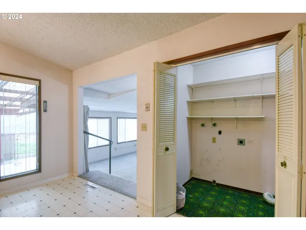 a kitchen view with appliances a sink cabinets and a window