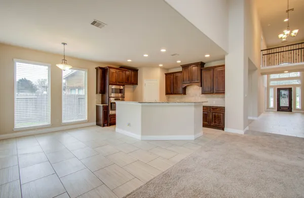a view of a kitchen with kitchen island wooden floor and a window