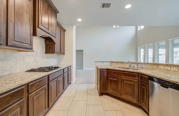 a kitchen with stainless steel appliances granite countertop a sink and stove top oven