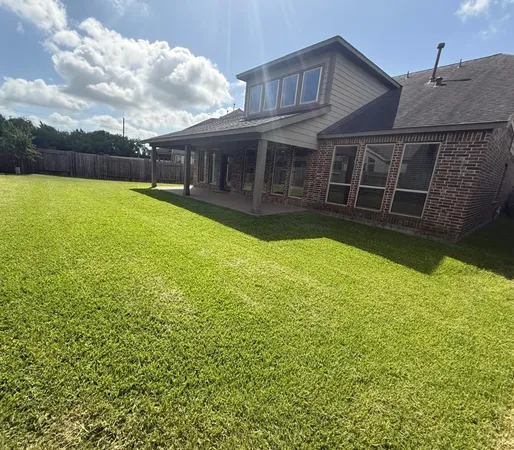 a view of a house with a swimming pool and a yard