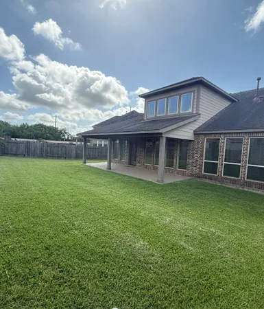 a view of a house with a yard and sitting area