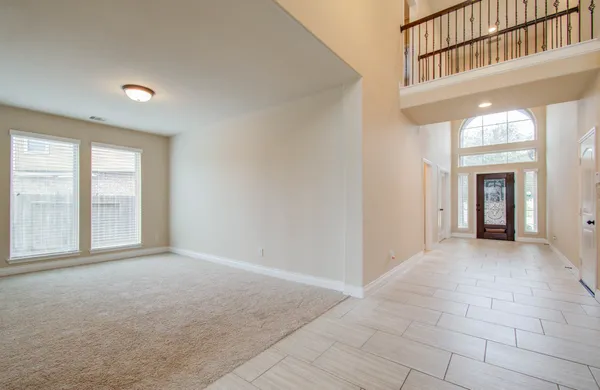 a view of an empty room with a fireplace and a window