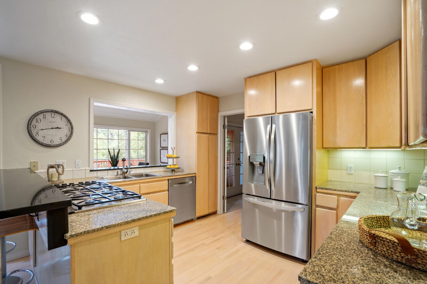 176 Swett Road Woodside, CA 94062 - Photo 13 of 39 a kitchen with stainless steel appliances granite countertop a refrigerator a stove and a sink