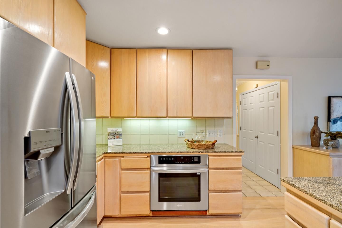 176 Swett Road Woodside, CA 94062 - Photo 14 of 39 a kitchen with a sink a refrigerator and cabinets