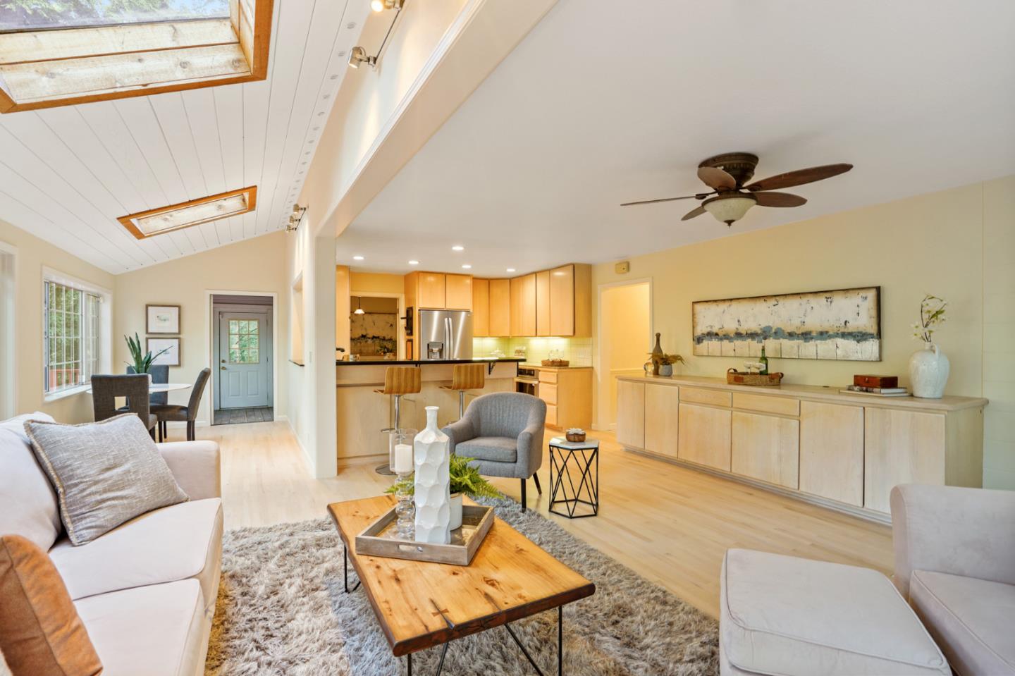 176 Swett Road Woodside, CA 94062 - Photo 18 of 39 a living room with furniture a rug kitchen view and a chandelier