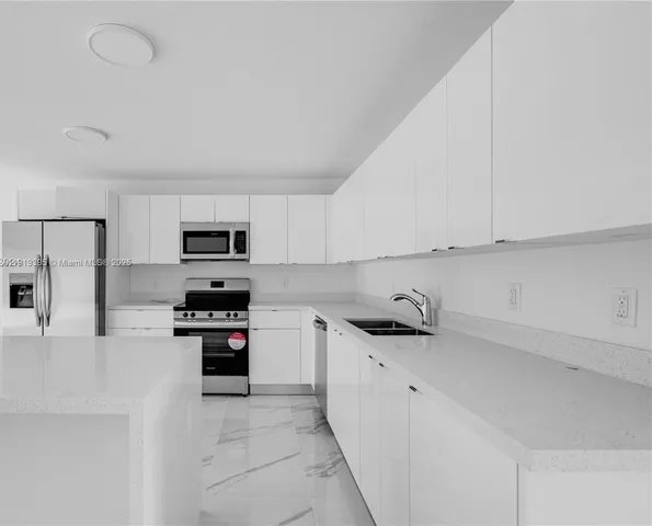 a kitchen with stainless steel appliances a stove sink and cabinets