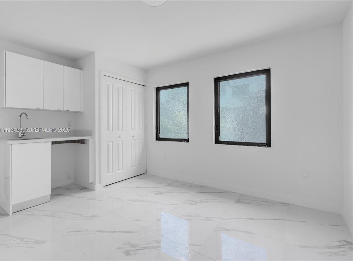 152 Northwest 18th Street Homestead, FL 33030 - Photo 8 of 11 a view of an empty room with window and cabinet