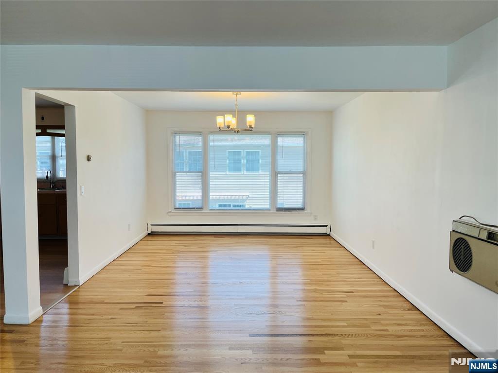 26 Pilgrim Court, Unit SECOND Bloomfield, NJ 07003 - Photo 2 of 12 a view of an empty room with wooden floor and a window