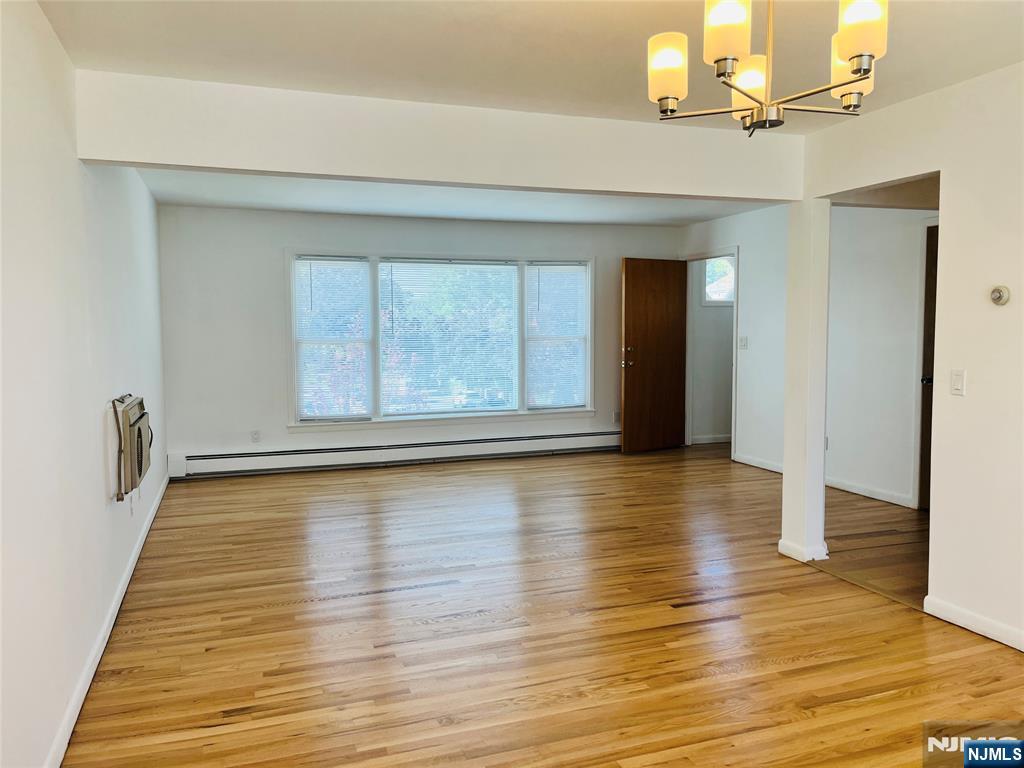 26 Pilgrim Court, Unit SECOND Bloomfield, NJ 07003 - Photo 4 of 12 wooden floor in an empty room with a window