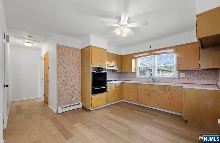 26 Pilgrim Court, Unit SECOND Bloomfield, NJ 07003 - Photo 5 of 12 a kitchen with stainless steel appliances granite countertop a refrigerator a sink dishwasher a stove and white countertops with wooden floor