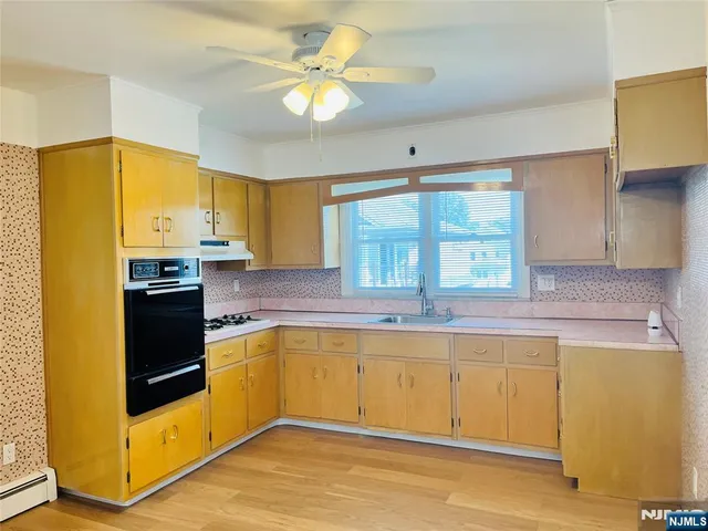 a kitchen with stainless steel appliances a stove a sink and a refrigerator