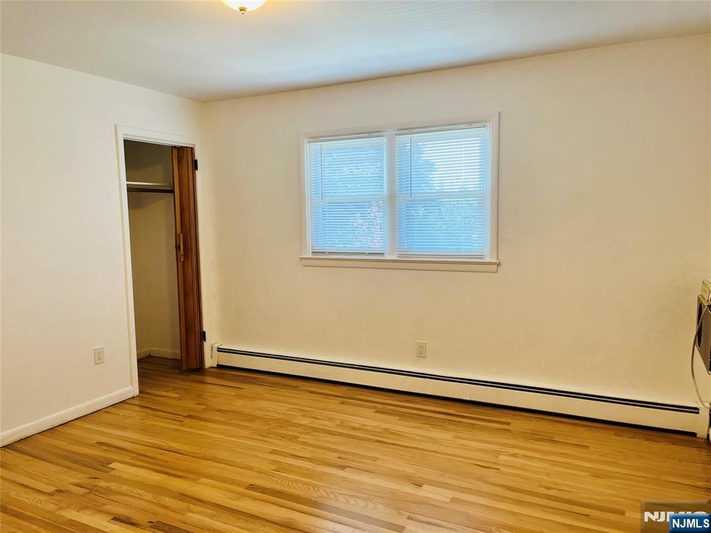 26 Pilgrim Court, Unit SECOND Bloomfield, NJ 07003 - Photo 9 of 12 a view of an empty room with wooden floor