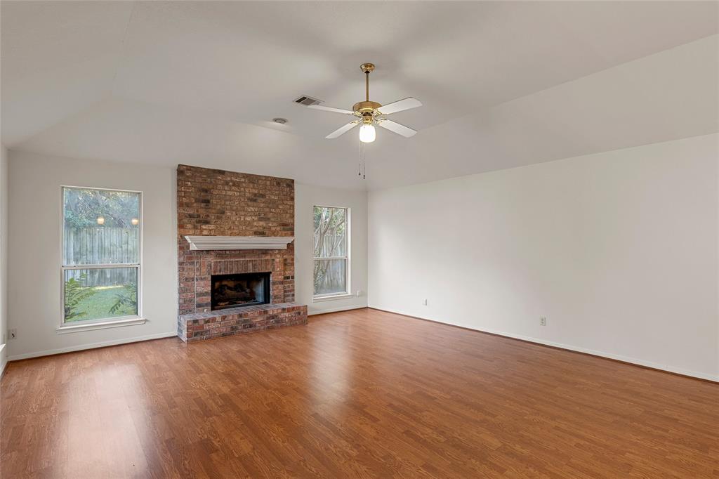3133 Chimney Hill Drive Waco, TX 76708 - Photo 19 of 29 an empty room with windows fireplace and a fireplace