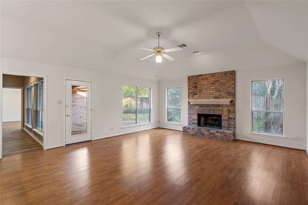 3133 Chimney Hill Drive Waco, TX 76708 - Photo 21 of 29 wooden floor fireplace and windows in an empty room