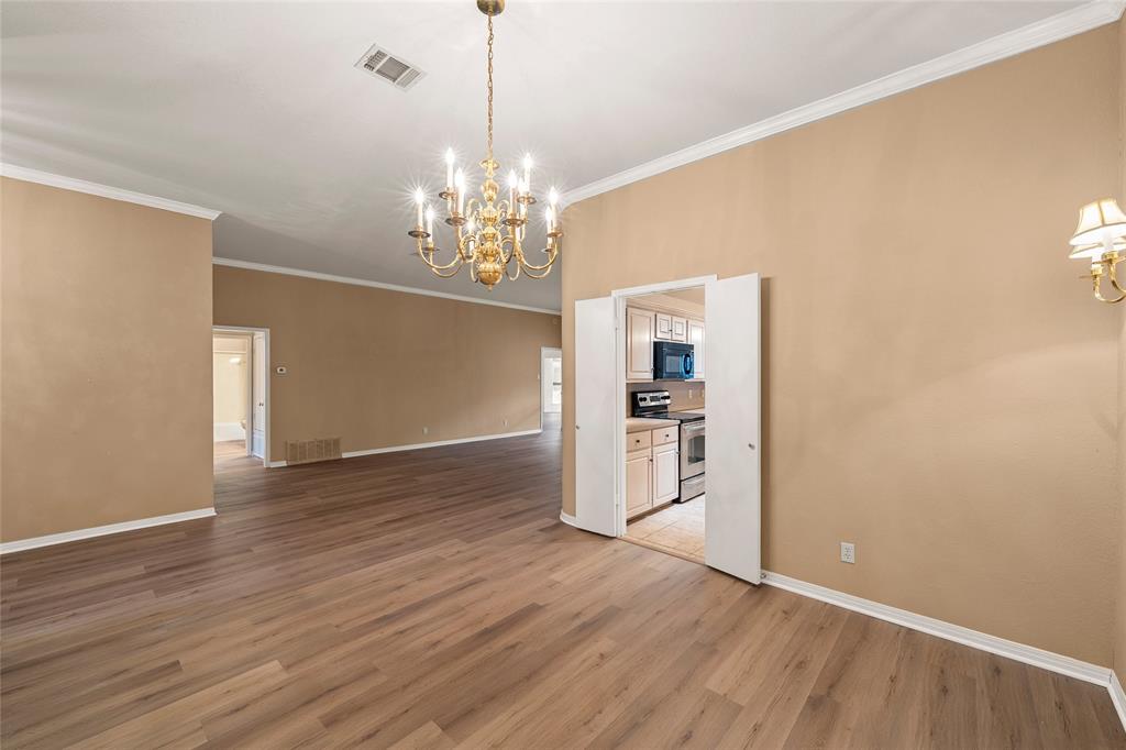 3133 Chimney Hill Drive Waco, TX 76708 - Photo 27 of 29 a view of a livingroom with wooden floor kitchen chandelier and a refrigerator