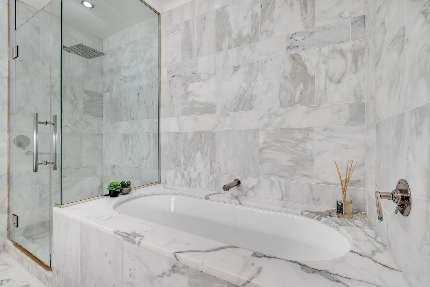 a bathroom with a tub sink and mirror