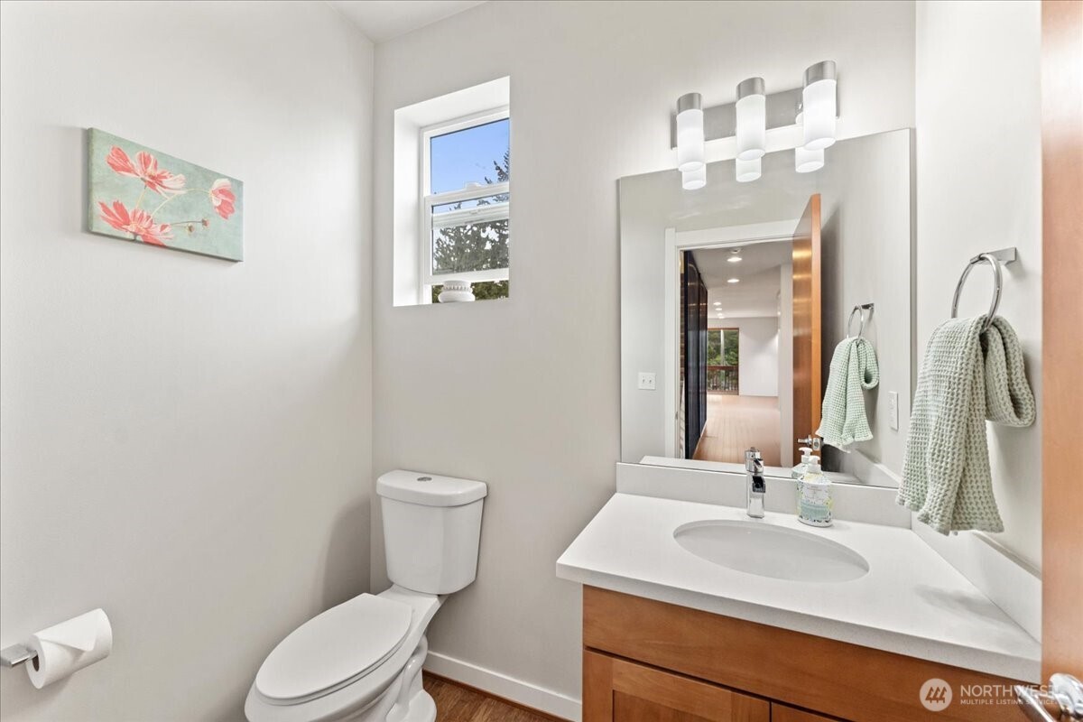 12418 2nd Place Southwest Burien, WA 98146 - Photo 11 of 39 a bathroom with a toilet a sink and mirror