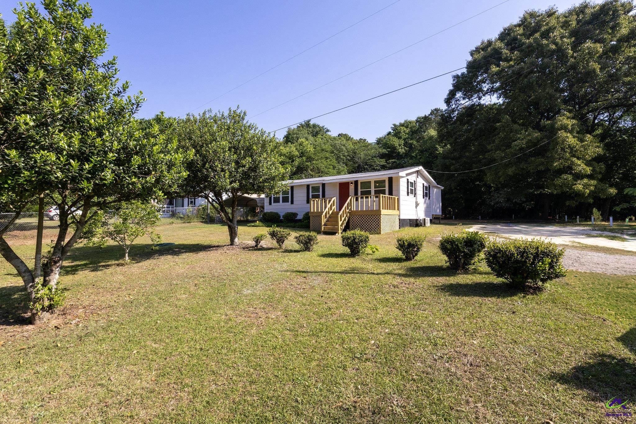 156 Churchwell Road Cochran, GA 31014 - Photo 3 of 20 a house view with swimming pool in front of it