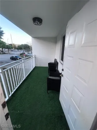 a view of a porch with furniture and garden