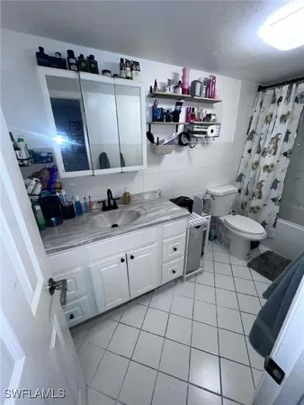a kitchen with a sink a stove and cabinets