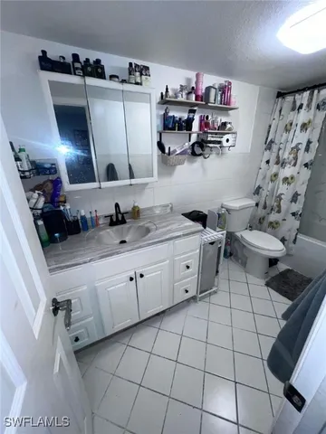 a kitchen with a sink a stove and cabinets