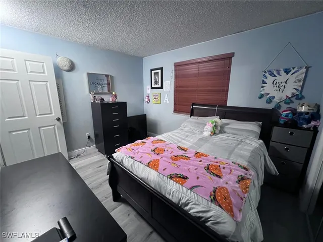 a bedroom with a bed and a dresser in it