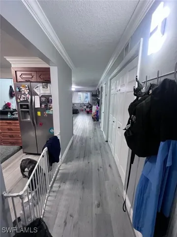 a view of a livingroom with furniture wooden floor and windows