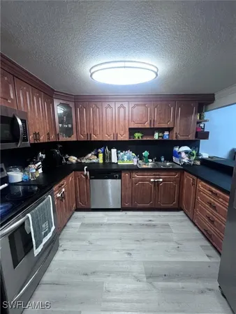 a large kitchen with stainless steel appliances and a sink
