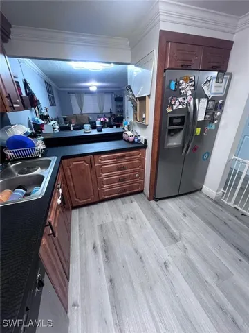 a kitchen with stainless steel appliances granite countertop a refrigerator and a counter space