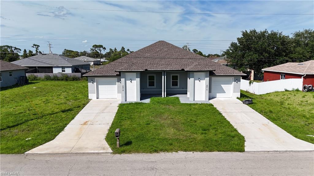 4816 24th Street Southwest Lehigh Acres, FL 33973 - Photo 29 of 32 a front view of a house with a yard