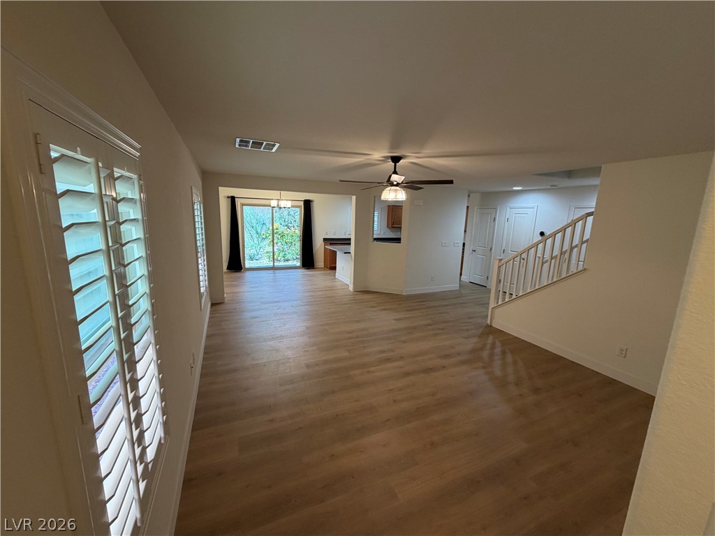 7879 Shoreline Ridge Court Las Vegas, NV 89166 - Photo 4 of 26 An open layout flows seamlessly across wood-look flooring beneath crisp neutral walls.
