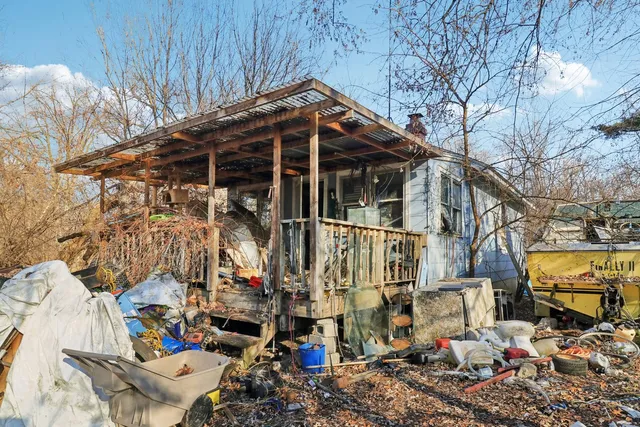 a view of a chairs and table in the backyard