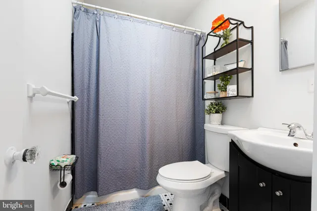 a bathroom with a toilet and a shower