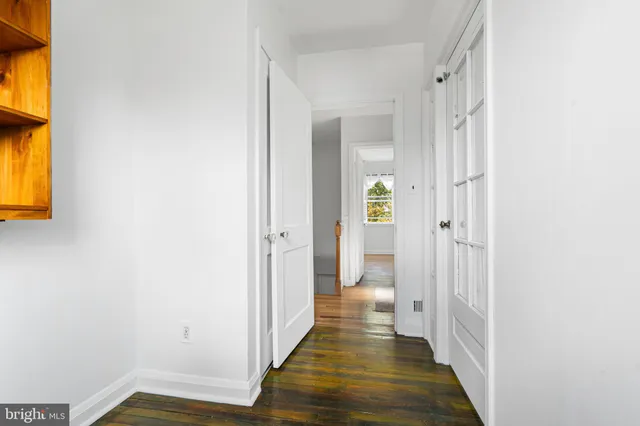 a view of a room with wooden floor and window