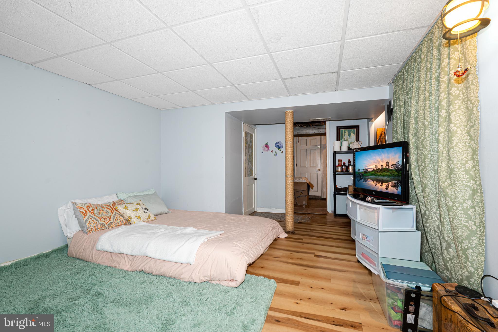 3454 McShane Way Baltimore, MD 21222 - Photo 18 of 35 a bedroom with a bed and a flat screen tv