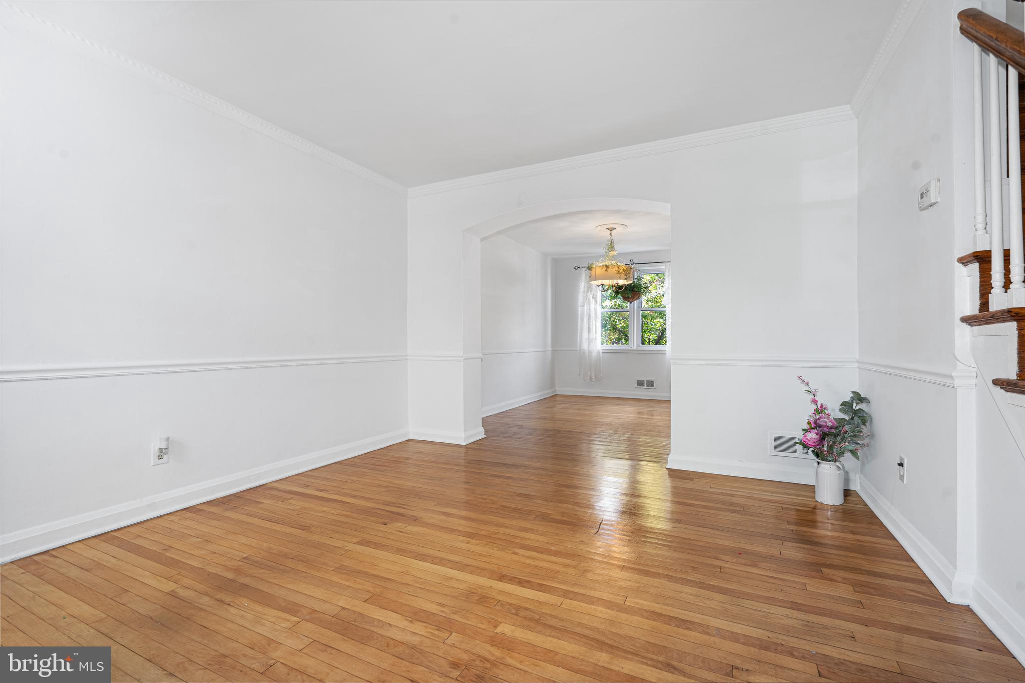 3454 McShane Way Baltimore, MD 21222 - Photo 2 of 35 a view of an empty room with wooden floor and a window